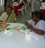Volunteer teaching participants how to use the FIT-kit on Registration Day in two local languages